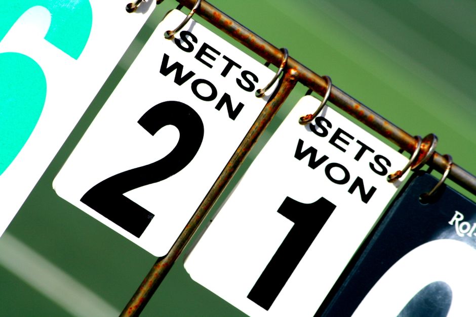 Close-up of a tennis scoreboard showing games won by each player.